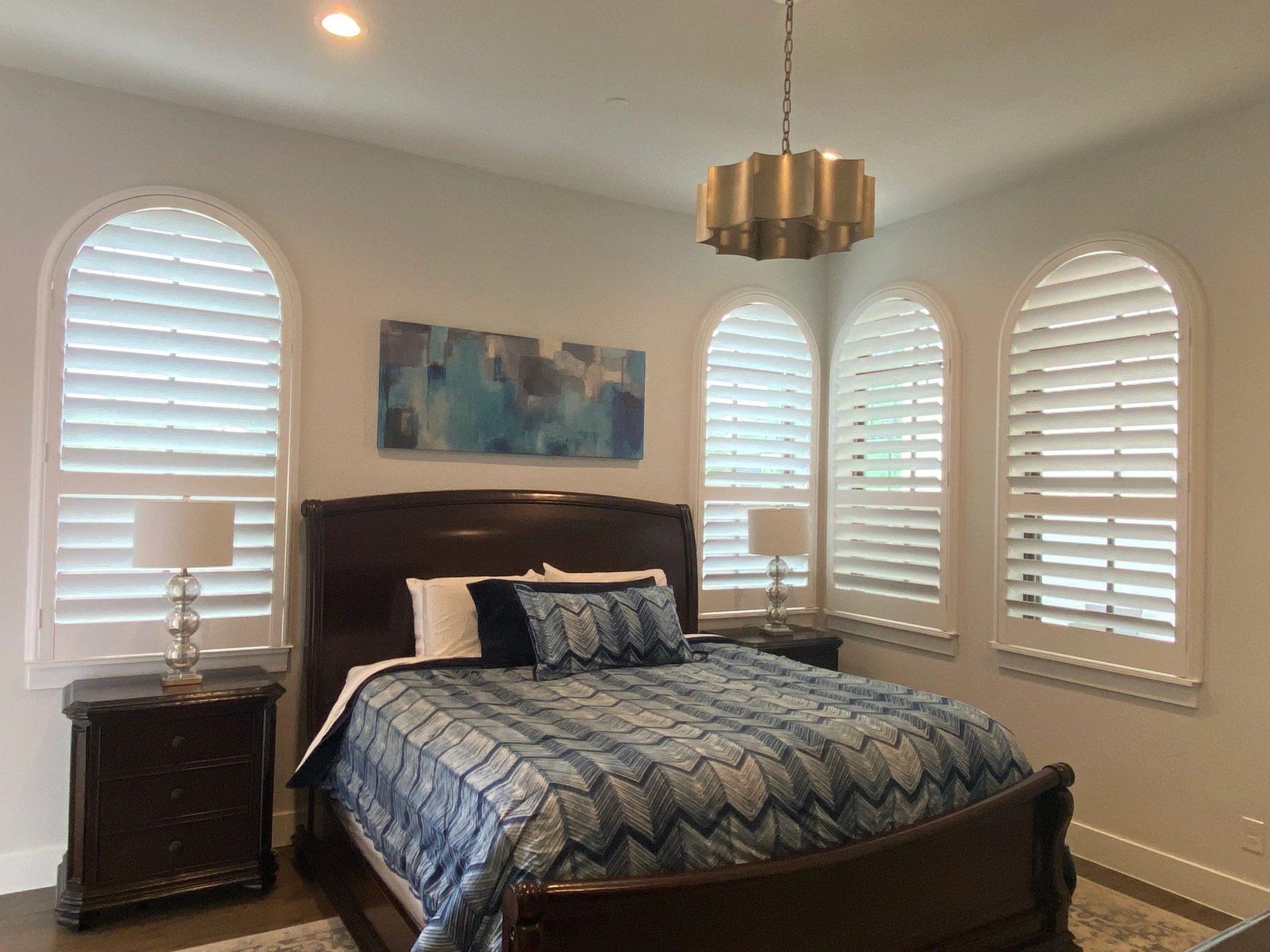 Bedroom with arched custom shutters