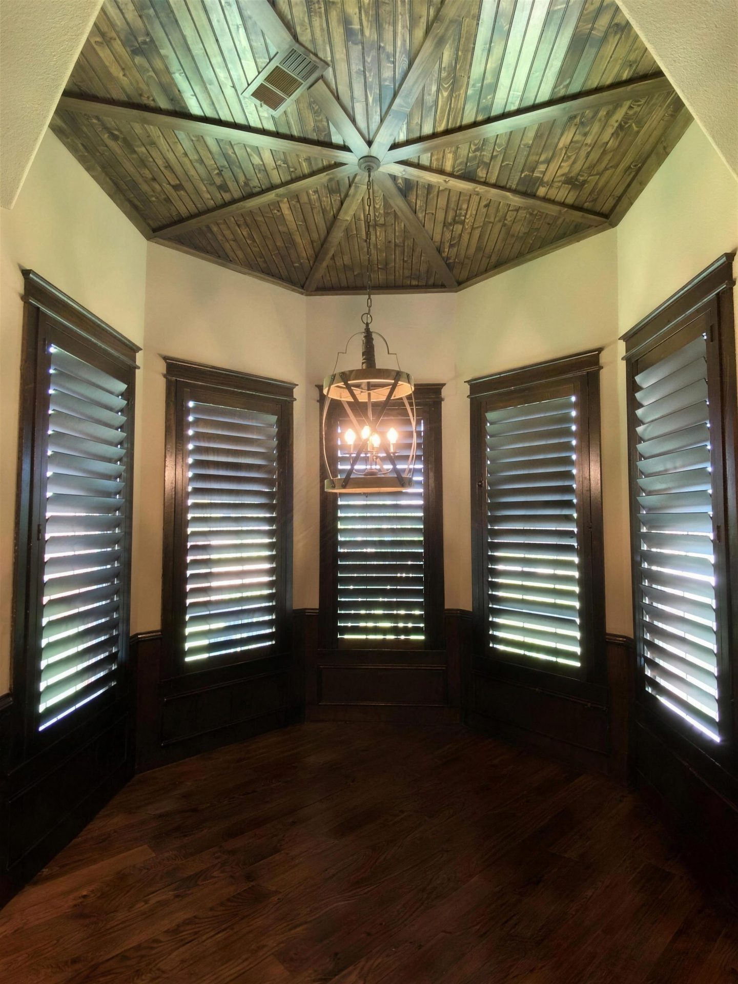 Octagonal turret room with dark wood shutters